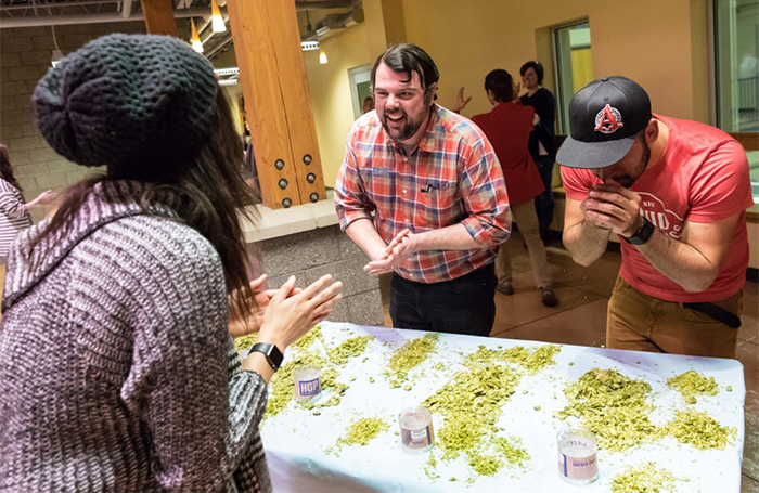 Fans rub hops to assess their aromatic qualities at Bell's Brewery in Comstock.
