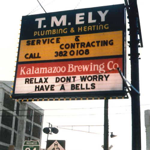 a vintage sign advertising bell's from beer history
