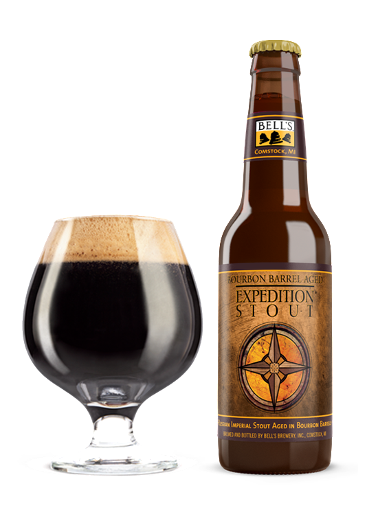 A full snifter glass sitting next to a bottle of Bourbon Barrel Aged Expedition Stout