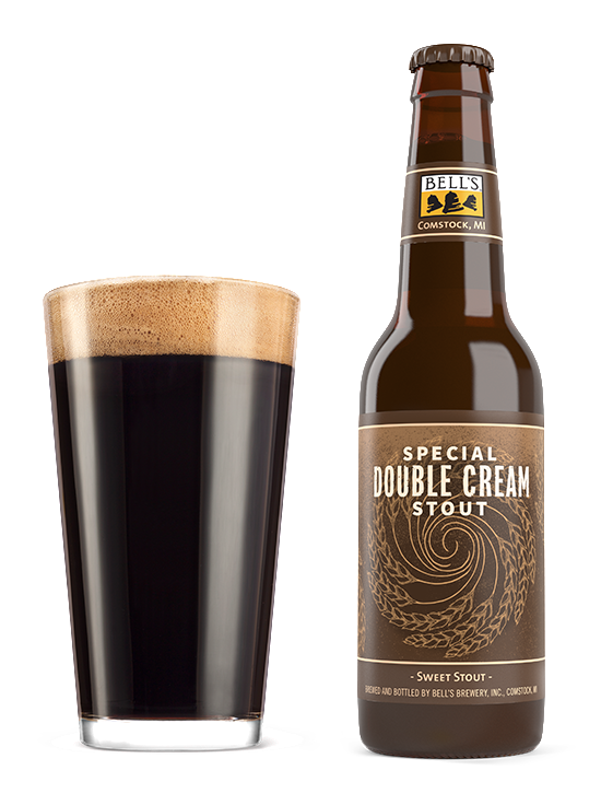 A full glass next to a bottle of Special Double Cream Stout