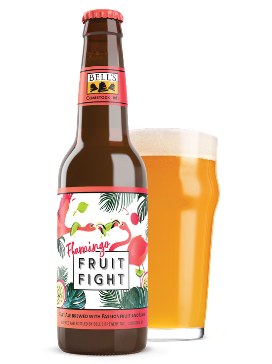 A bottle of Flamingo Fruit Fight sitting in front of a full nonic glass
