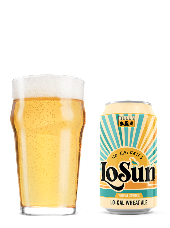 A full nonic glass sitting next a can of LoSun