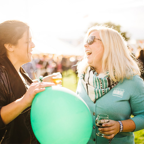 two women laughing at the bells funvitational 30th anniversary beer festival