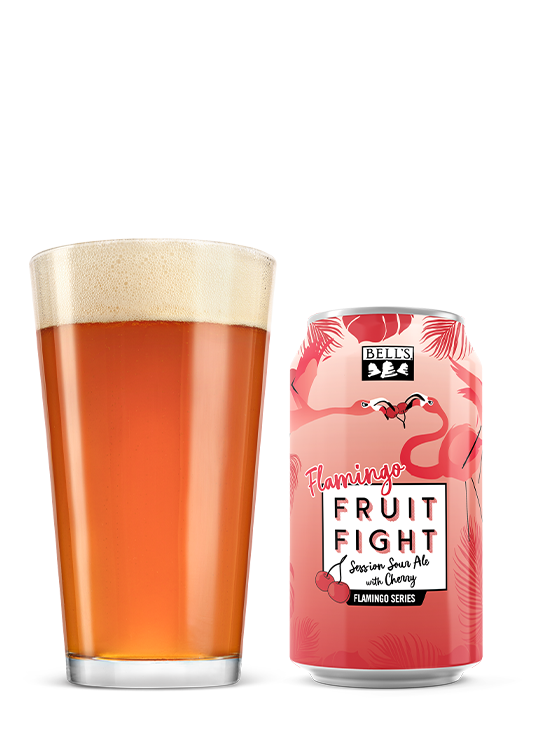 A pint of beer next to a can of Flamingo Fruit Fight Sour Cherry.
