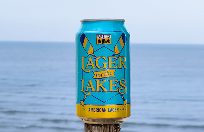 A can of Bell's Lager for the Lakes on a tree branch looking out on Lake Michigan