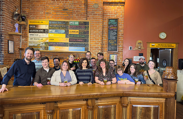 Gov Whitmer, Jordan Klepper and staff from Bell's at the bar at the Eccentric Café