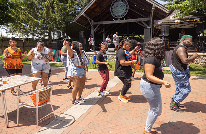 People dancing in the beer garden during the Juneteenth 2022 celebration.