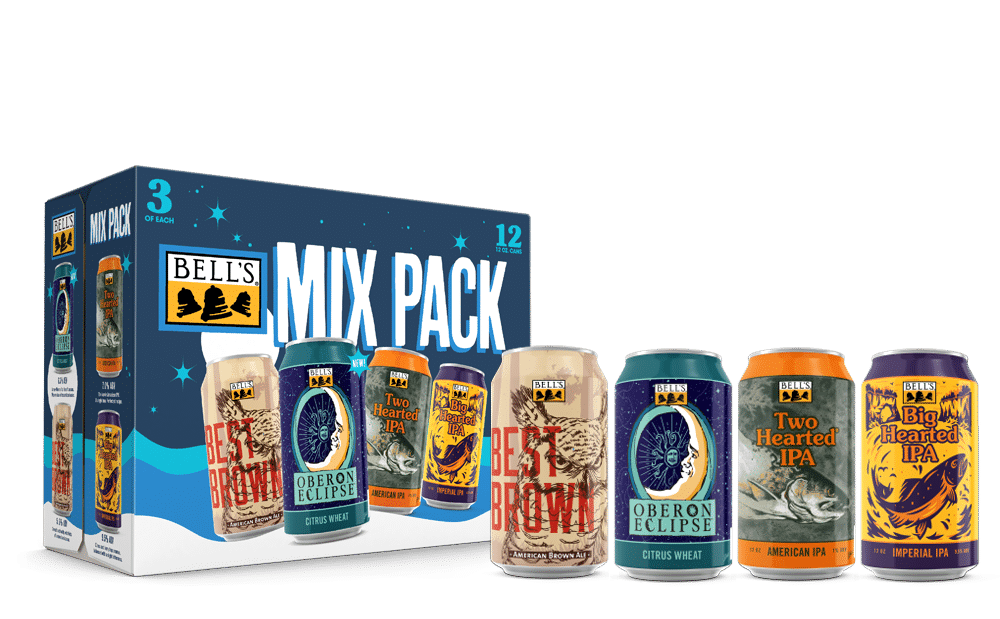 A 12 pack case of bell's mix pack, with a can of best brown, oberon eclipse, two hearted ipa and big hearted ipa on display in front