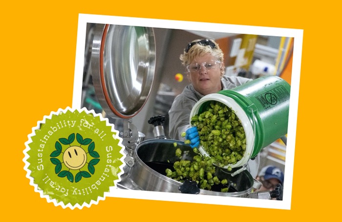 Bonnie pours a bucket of green hops into a tank at the brewery