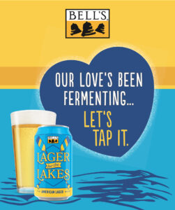 A can of Bell's Lager of the Lakes beside a pint glass with a heart and the text "OUR LOVE'S BEEN FERMENTING... LET'S TAP IT." against a yellow and blue background.