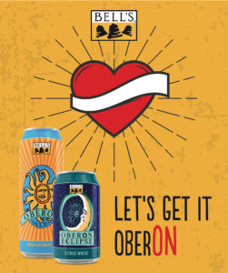 Bell's Oberon Ale and Oberon Eclipse cans are presented in front of a heart graphic with sun rays on a yellow backdrop, accompanied by the phrase "LET'S GET IT OBERON."