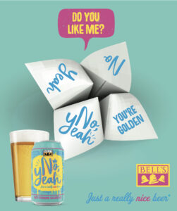A colorful paper fortune teller with phrases such as "No," "yeah," and "YOU'RE GOLDEN," displayed next to a can of Bell's No, Yeah Golden Ale on a teal background.