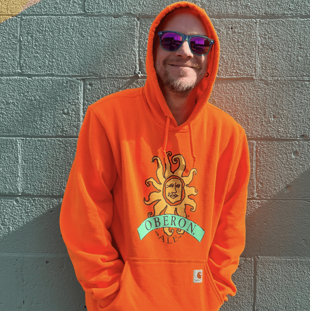 Short sleeve, orange tie-dye t-shirt with the oberon logo in white on the left breast