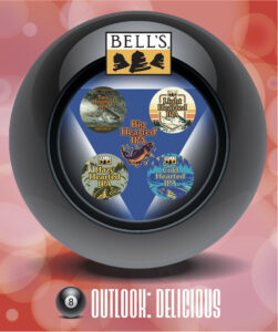 A Magic 8-Ball design with the Bell's logo at the top and a variety of Bell's beer labels visible inside the window, including "Two Hearted IPA," and "Light Hearted IPA." The phrase "OUTLOOK: DELICIOUS" is displayed at the bottom.