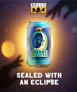 A Bell's Oberon Eclipse beer can is presented with a cosmic background, complete with stars and a glowing moon, along with the phrase "SEALED WITH AN ECLIPSE."