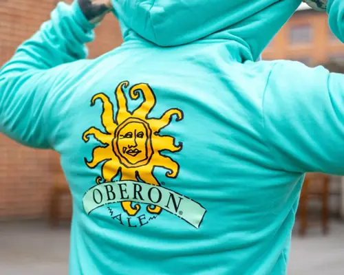 Teal full zip hoodie with the oberon logo on the back.