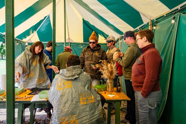 People in a large tent doing crafts